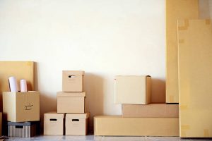 empty cardboard boxes for moving, in an empty room, relocation and repair.